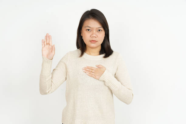 Swearing Gesture of Beautiful Asian Woman Isolated On White Background Swearing Gesture of Beautiful Asian Woman Isolated On White Background association of southeast asian nations photos stock pictures, royalty-free photos & images