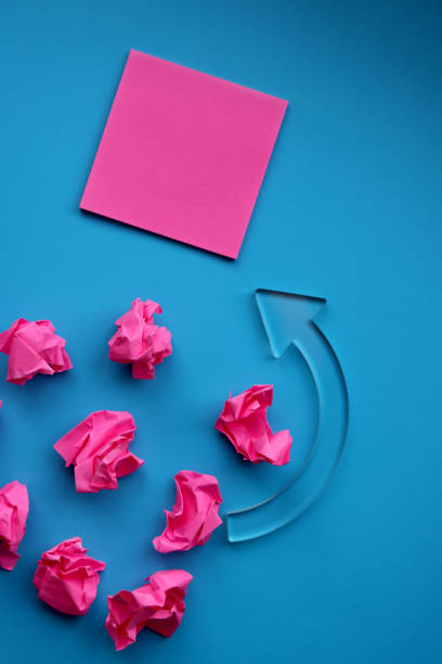 istock Adhesive note and paper balls on blue background 1364132150