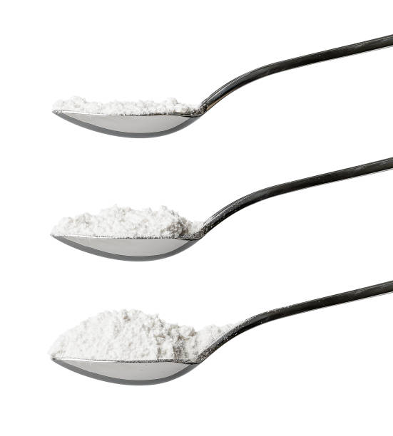 Three teaspoons of white flour side view Set of three teaspoons of refined white flour showing side view of level, rounded and heaped measurements isolated on a white background tsp stock pictures, royalty-free photos & images