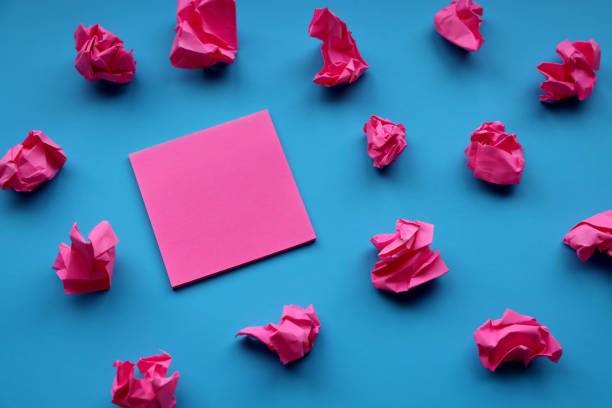 istock Adhesive note and paper balls on blue background 1364134001