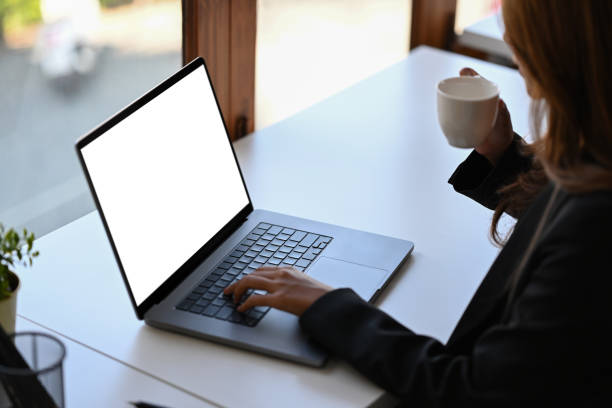 istock Cropped shot businesswoman drinking coffee and checking email on computer laptop. 1364135361