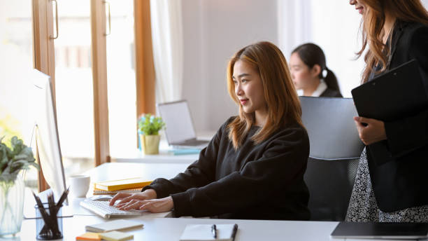 istock Business trainee or employee showing her work to her manager. 1364135454