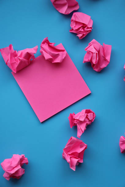 istock Adhesive note and paper balls on blue background 1364135517