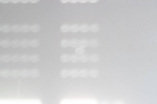 istock Lights shadows. Abstract light, black shadow overlay from window on white texture wall. Sunlight architecture background. Textures Light reflection from the window. 1364135645