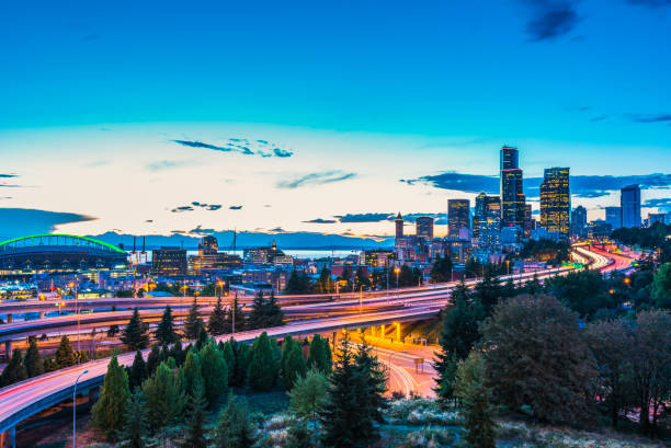 seattle skylines and interstate freeways converge at sunset, seattle, washington, usa. - seattle night skyline architecture and buildings imagens e fotografias de stock