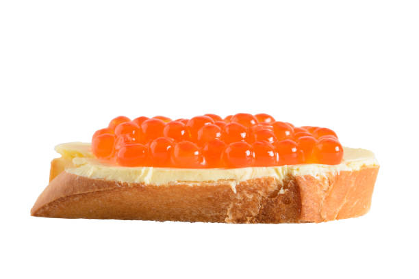 Sandwich with red caviar, focus in the foreground. Isolated on a white background.