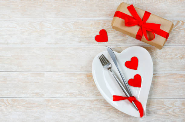 istock valentines day table setting flat lay with love white ceramic plate shape heart, festive decoration, fork and knife and red eco friendly zero waste gift box copy space text 1364142845
