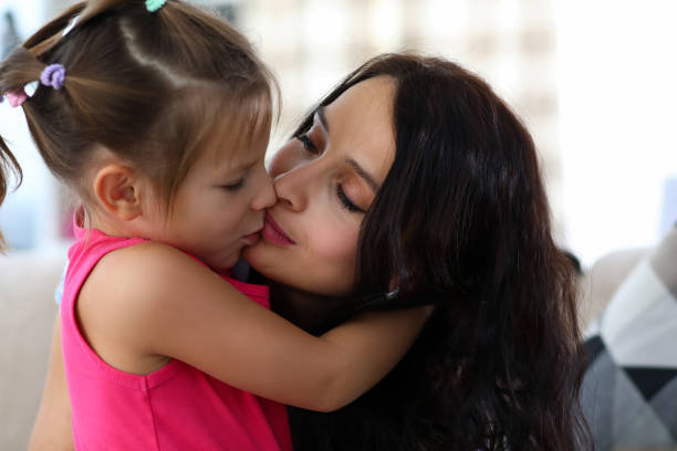 istock Mother kissing little child 1364143505