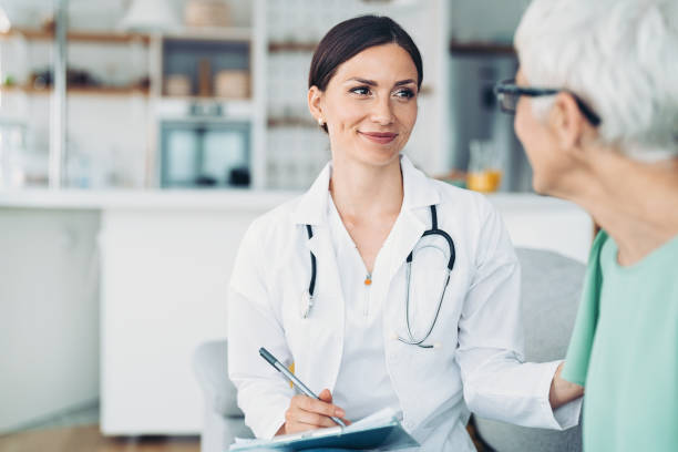 istock Young doctor consoling a senior patient 1364144542