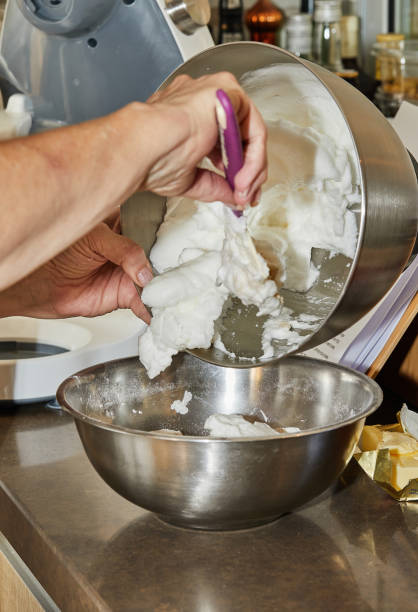 istock Chef puts the beaten egg whites into pie bowl 1364145456