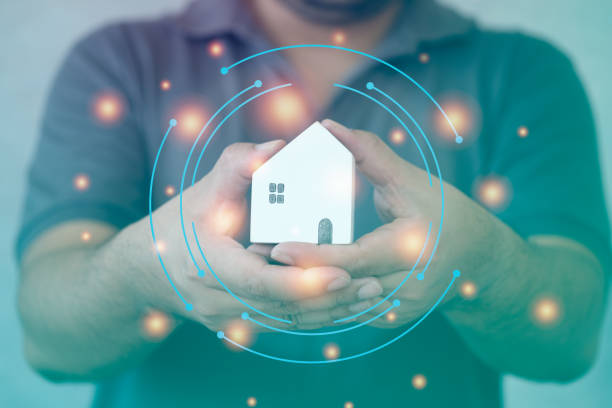 istock Man hand hold mini wood house model protecting with a virtual digital interface 1364145471