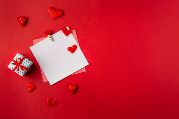 istock Mockup blank greeting card for valentines day. Composition with red hearts for Valentine's Day on red background. Flat lay. Love and relationships concept. 1364145586