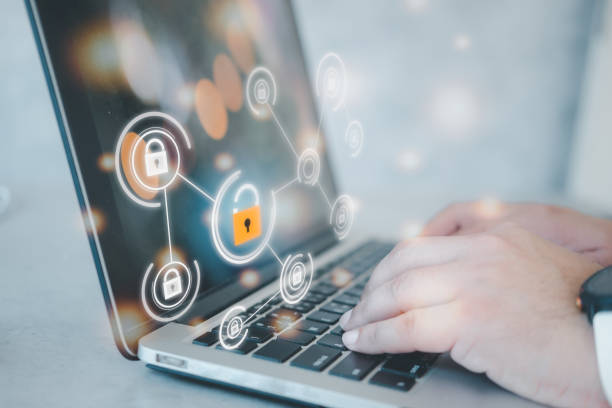 istock Man on his laptop in the office with the icon security key lock and unlock on the virtual display. 1364145705