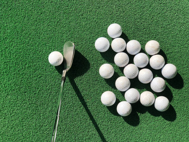 istock Groups of practice golf ball on artificial grass mat with one club iron 1364147336