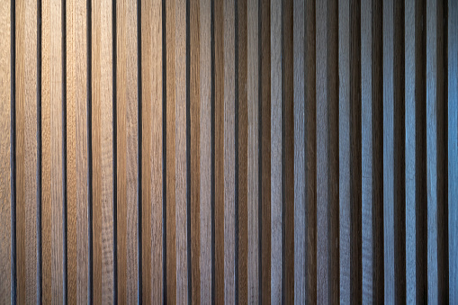 Warm light illuminates regular and neat wooden lines