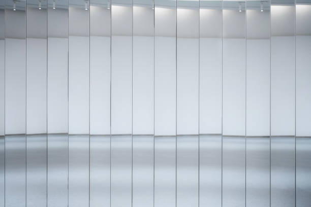 The mirrors of the bright, clean, empty interior buildings reflect