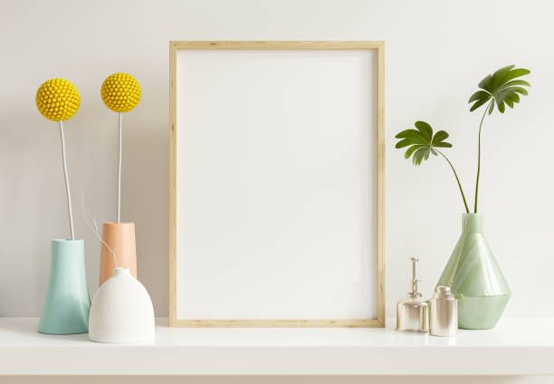 istock Vertical wooden frame mockup with green plants on white wall background. 1364148362