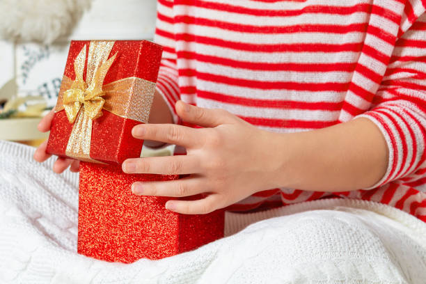 istock Woman looking into red shiny gift box 1364151573