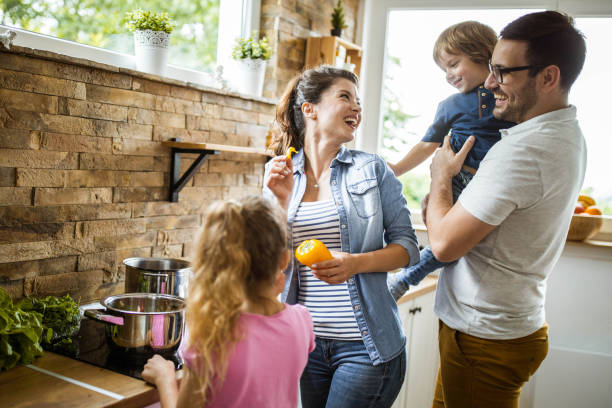 istock Happy family having fun while making lunch in the kitchen. 1364152418