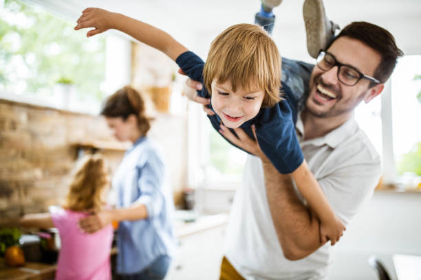 istock Happy boy having fun with his father in the kitchen. 1364152493