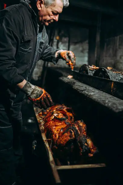 Photo of Men and roasted pig