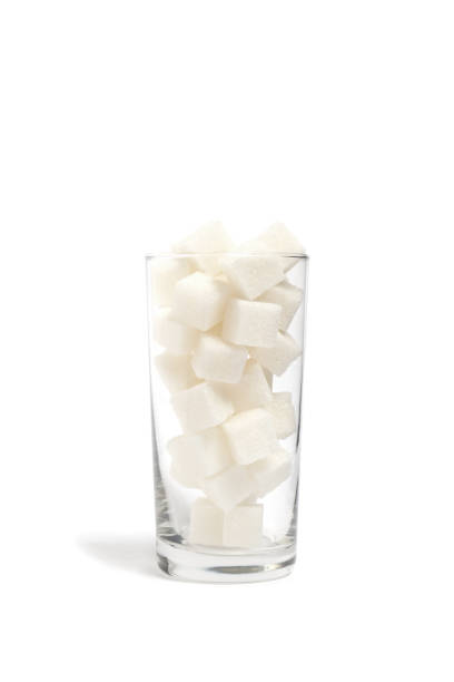 istock Refined sugar cubes in a clear glass glass. 1364155902