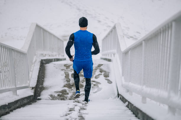 istock Man running outside on a cold winter day. 1364160452