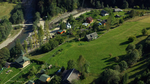 istock Drone mountain small village warm sunny spring day green grass fields valley 1364163072