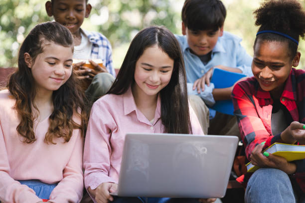 istock Student girl use laptop computer with friend at park 1364167910