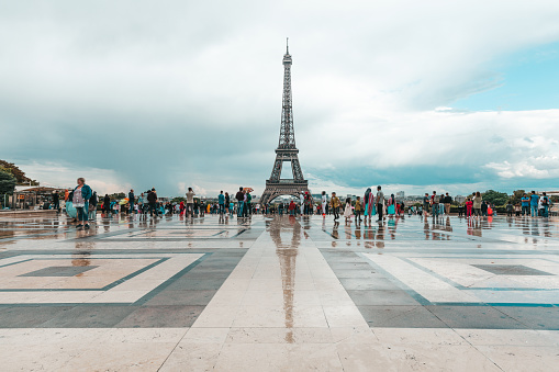 View of the Eiffel Tower in a rainy day with reflections on the Trocadero floor