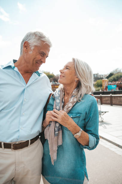 istock Seniors taking a break in Paris relaxing by the Seine River in Paris 1364169684
