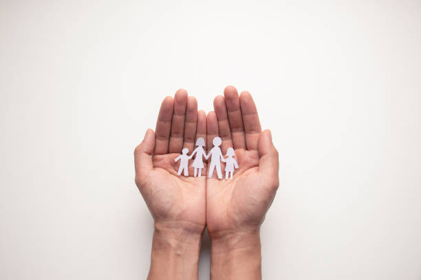 istock Paper family in hands isolated on white background. 1364171891