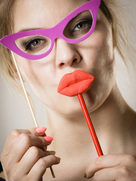 istock woman holds carnival accessories on stick 1364172472