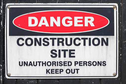 Danger, construction site sign on a wall.