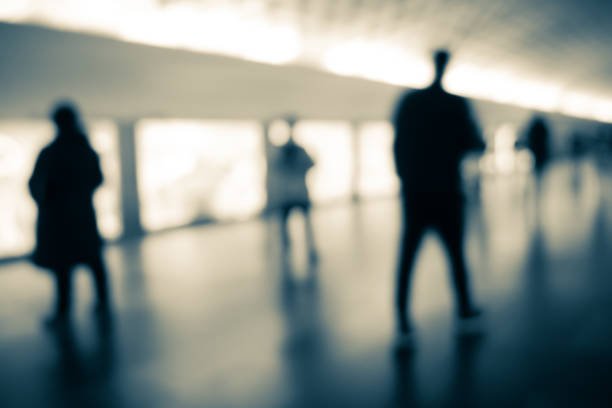 istock Blurry human silhouette in a subway. Moving human silhouettes in blur. 1364172731