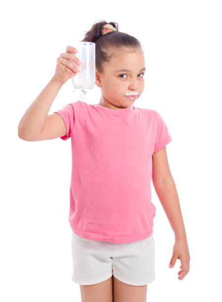 Confident Girl Holding Glass of Milk stock photo