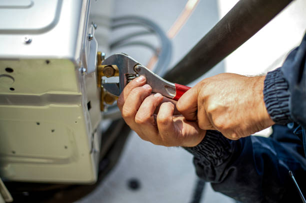 istock Air conditioner technician services outdoor AC unit and the Gas Generator 1364172977