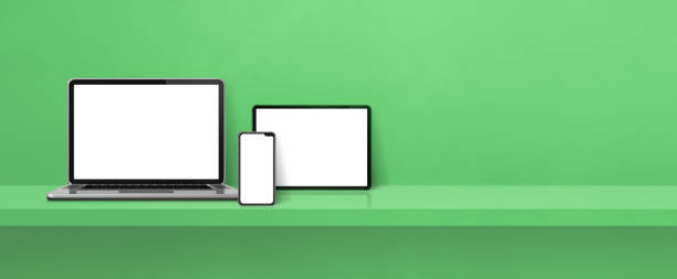 istock Laptop, mobile phone and digital tablet pc on green wall shelf. Banner background 1364178168