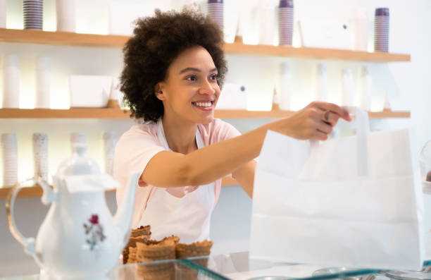 istock Happy woman working at an ice cream parlor 1364179856