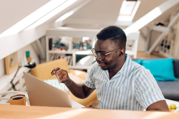 istock Young African American making an online payment from home 1364180348