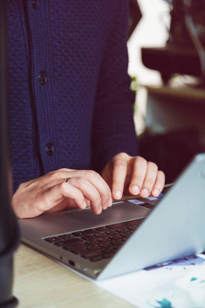 istock Male hands typing on the notebook keyboard.Concept of young people work mobile devices 1364184528
