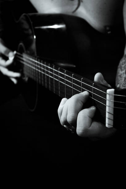 istock Man playing guitar and singing shirtless 1364184902