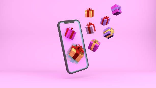 istock 3d gifts and smartphone background. Festive pink bright backdrop with empty screen phone and boxes of gifts for valentine's day or other holiday. 1364187374