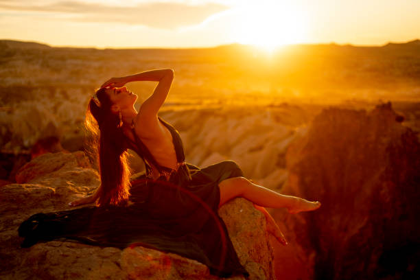 istock young woman dancing at sunset 1364188365