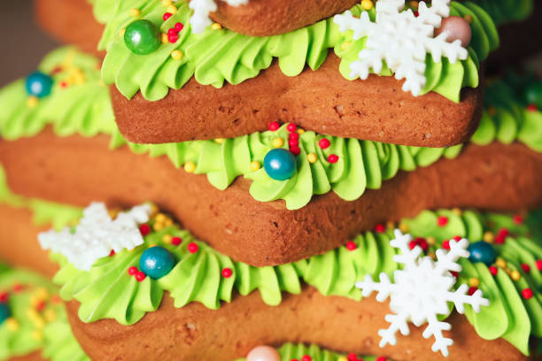 Gingerbread christmas tree decorated colored icing, bakery background. Holiday cookie in shape of christmas tree for new year's day, christmas, winter holiday
