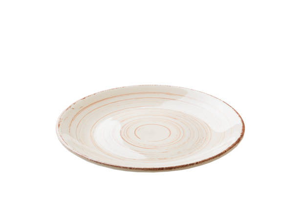 istock milky color ceramic round plate isolated over white background. perspective view 1364191590