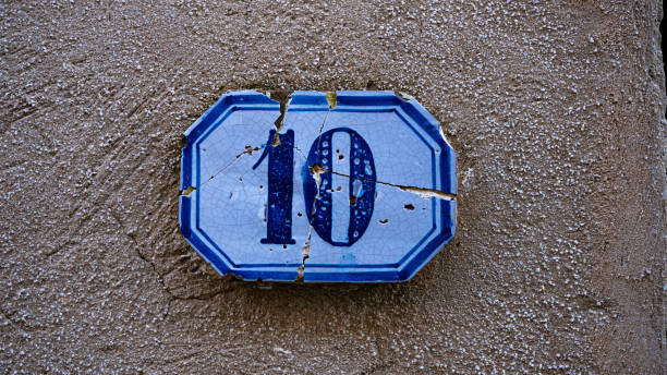 istock House number 10. on ceramic plate with blue writing. number ten. 1364194847