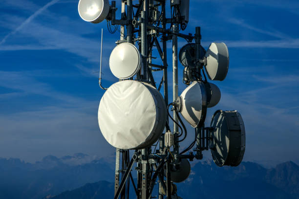 An outdoor remote telecom tower against a blue sky