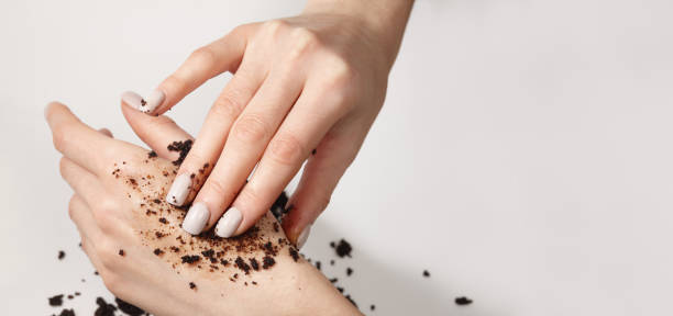istock Woman applying coffee scrub to her hand, close up view 1364197826