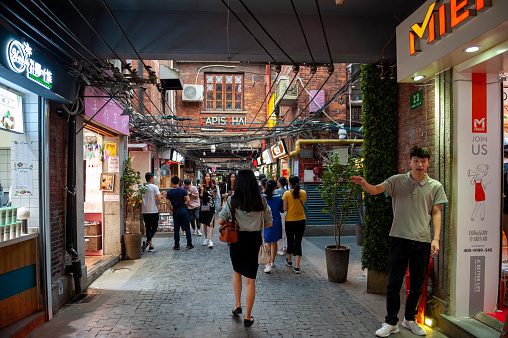 Shanghai, China - September 2019: Tianzifang, a popular tourist destination home to boutique shops, craft stores, trendy art studios, cafes, bars and restaurants along narrow alleys in Shanghai, China